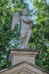 Obraz premium little angel made of stone, sculpture of a child angel on the roof of an old church in the city of Zadar Croatia
