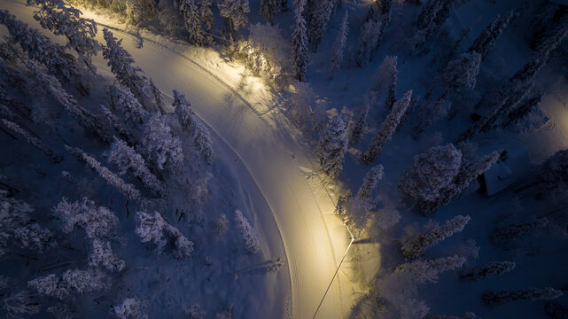 Aerial view of  illuminated cross-country ski trails, winter evening in Lapland
