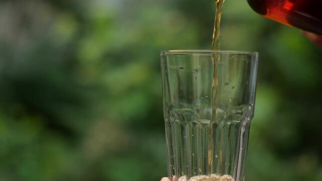ice tea being poured into a glass