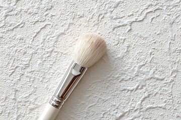 Applying Cream with Brush on Textured White Surface  
