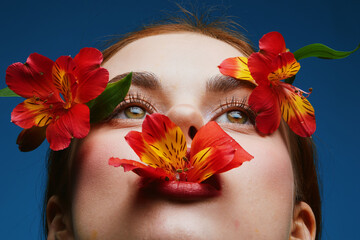 Close up of a woman with vibrant flowers adorning her face, embodying beauty and nature s harmony,...
