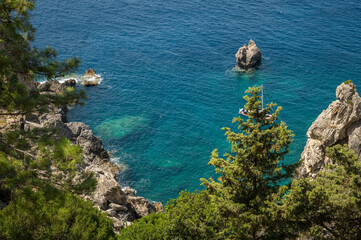 Aerial View of Rocky Coast and Sailboat in Paleokastritsa, Corfu