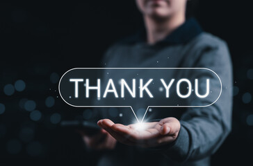 Thank You Message and Appreciation Concept. A person presenting glowing Thank You message, symbolizing gratitude, customer appreciation, communication, and positive feedback in digital interaction.