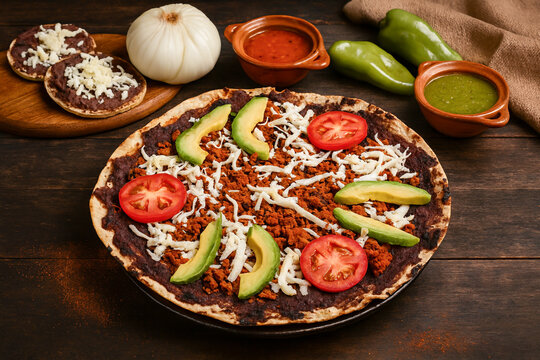 Traditional Oaxacan tlayuda with chorizo, avocado and tomato