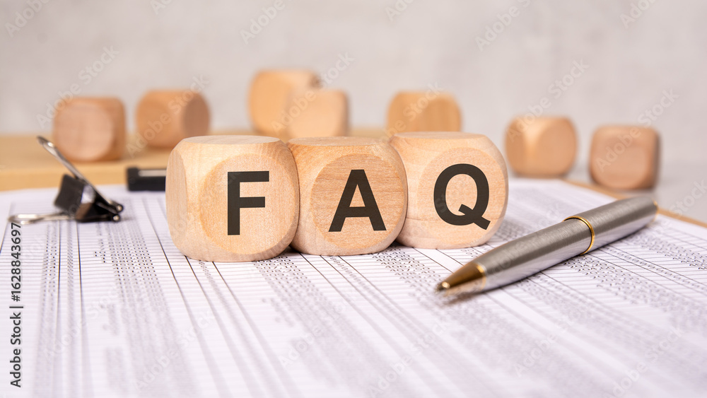 Poster wooden blocks with faq letters on financial report sheet and calculator in background