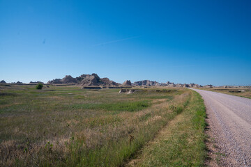 Winding road through rocky formations under clear blue sky