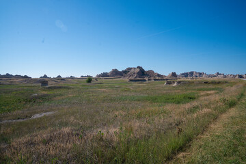 Winding road through rocky formations under clear blue sky