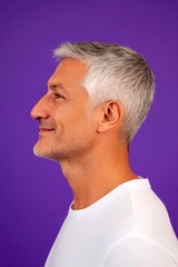 Fototapeta premium Creative of style for aging men. Elegant men's curtain bangs haircut - midlife middle eastern man with short hair. Purple solid background. A gentle and elegant man with a warm presence.