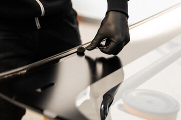 Applying black primer on car frame ensures strong adhesion. Applying primer on car frame before...