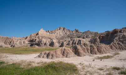 Eroded rock formations under blue sky in Badlands National Park, South Dakota