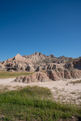 Eroded rock formations under blue sky in Badlands National Park, South Dakota