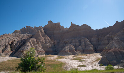 Open grassland with distant rock formations in Badlands National Park, South Dakota
