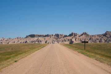 Winding road through rocky formations under clear blue sky