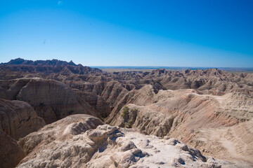 Layered rock formations under clear sky in Badlands National Park, South Dakota