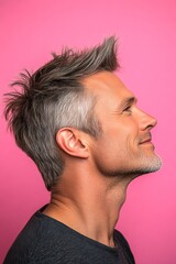 Obraz premium Concept layout of style for aging men. A stylish and glowing male with a relaxed aura. Pink solid background. Trendy men's quiff haircut - midlife white man with hair.