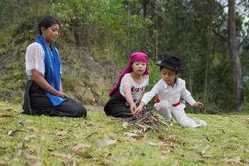 Indigenous children learning to build a fire in the countryside