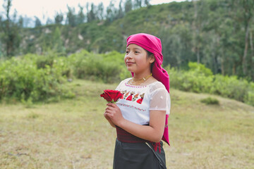 Indigenous girl holding red rose in the andean highlands