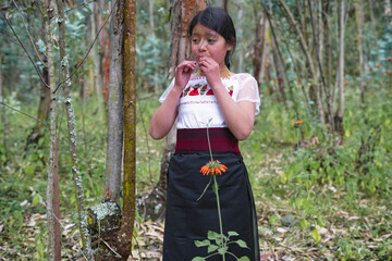 Indigenous girl eating wild berries in ecuadorian forest