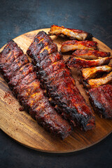 Barbecue tandori masala pork spareribs St Louis cut with hot rub  on a wooden cutting board