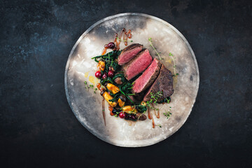 Barbecue dry aged beef steak - roast beef medium english roasted, sliced with wild mushrooms, chetnuts, greens and cranberries