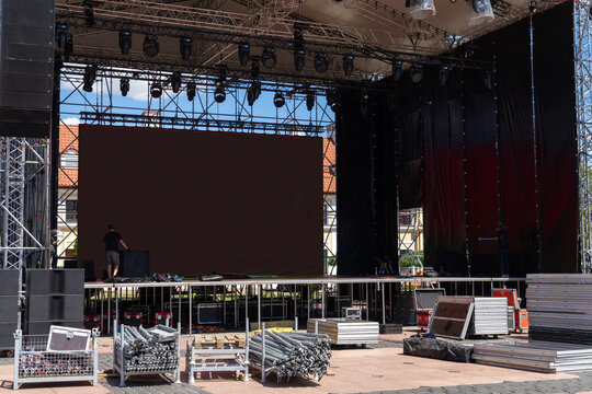Workers installing sound and stage equipment