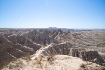 Eroded rock formations under blue sky in Badlands National Park, South Dakota