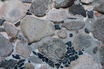 Image of Old ancient gray stone wall close up. Texture for background usage.