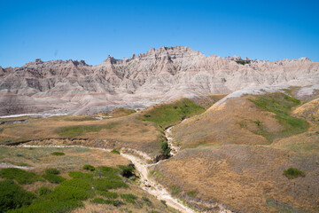 Colorful eroded hills and green vegetation in Badlands National Park, South Dakota