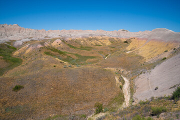 Colorful eroded hills and green vegetation in Badlands National Park, South Dakota