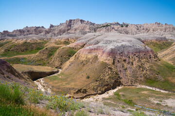 Colorful eroded hills and green vegetation in Badlands National Park, South Dakota
