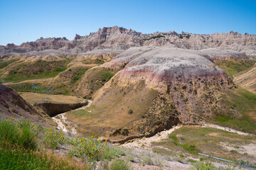 Colorful eroded hills and green vegetation in Badlands National Park, South Dakota