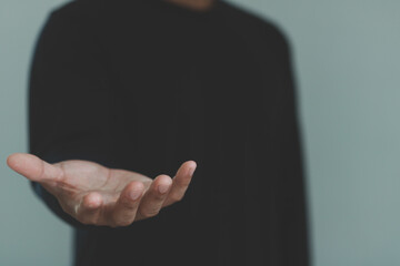 Male hand reaching out with an open palm, isolated against background, offering help, receiving support, sharing, asking, charity, handshake or professional presentation for business, communication.