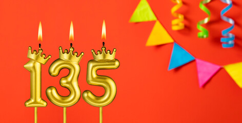 Number 135 candle - Birthday celebration on an orange background with pennants