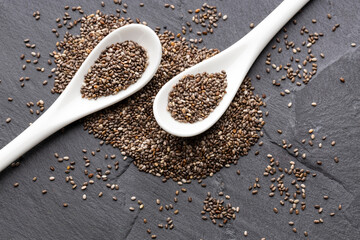 Organic fresh chia seeds in two spoons - Salvia hispanica.