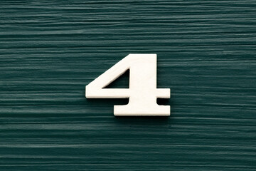 Number 4 white piece on a rustic dark green background