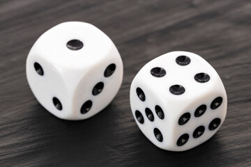 Two board game dice - White die with black dots