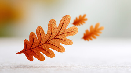Autumn leaf in focus: close-up of vibrant orange oak leaf in gentle fall breeze