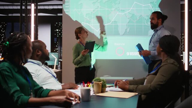 Diverse staff from an enterprise sharing data analytics and insights for a new project agenda during late night corporate meeting. Workers discuss about resources allocation. Camera A.
