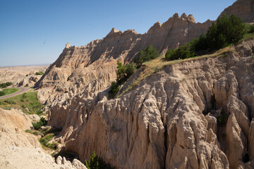 Eroded rock formations and green trees in Badlands National Park, South Dakota