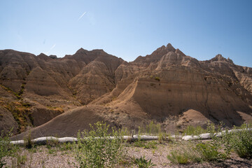 Sharp rock formations and desert vegetation in Badlands National Park, South Dakota