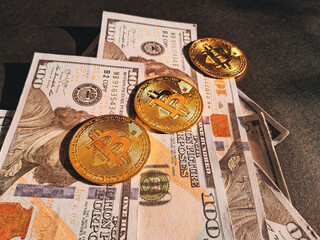 Golden Bitcoin coins placed on prop US dollar bills