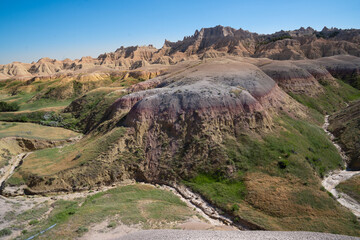 Colorful eroded hills and green vegetation in Badlands National Park, South Dakota
