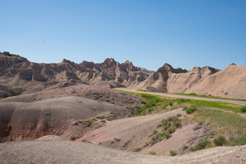 Colorful eroded hills and green vegetation in Badlands National Park, South Dakota