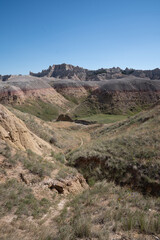 Colorful eroded hills and green vegetation in Badlands National Park, South Dakota