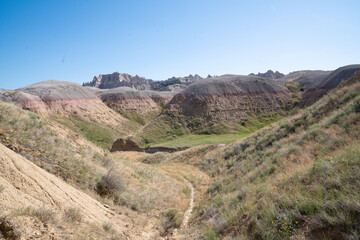 Colorful eroded hills and green vegetation in Badlands National Park, South Dakota
