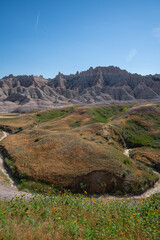 Eroded grassy hills and rock formations in Badlands National Park, South Dakota