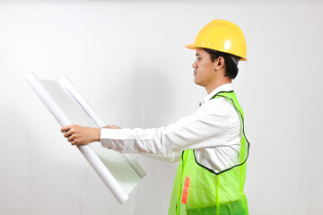 Asian construction worker holding blueprint in hand looking seriously isolated on white background.Concept Engineer and business work. Success.