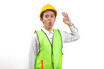 Surprised Young Construction Worker with Safety Vest and Hard Hat Gesturing Okay