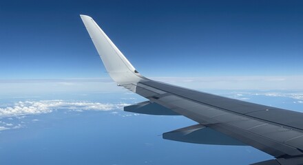 Fototapeta premium Airplane wing over clouds