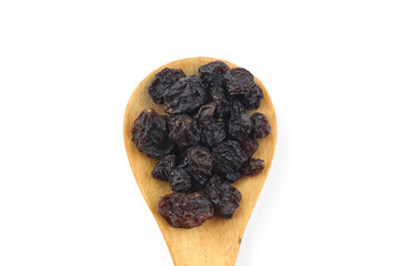 raisins in a spoon isolated on white background.